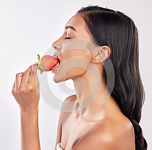 Woman, skincare and studio profile with strawberry, eating and wellness with beauty, natural glow and health. Model