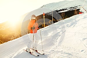 Woman on skis during winter. Girl skiing in a mountain resort on the slopes