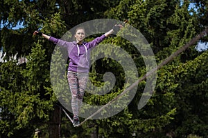 Woman slacklining at sunny day