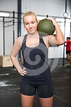 Woman with slam ball at fitness gym center