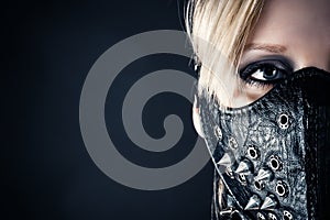 Woman slave in a mask with spikes