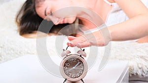 Woman sleep on the bed turns off the alarm clock wake up at the morning, Selective focus.