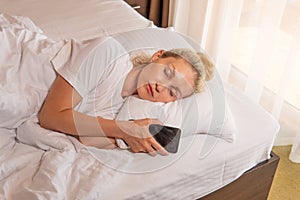 Woman sleep mobile blonde phone beautiful bed blanket view morning, for female caucasian for person for happy nap, room