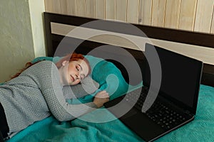 Woman sleep near laptop in bed home