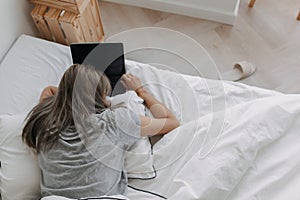 Woman sleep on tablet computer on bed in the morning. Early online work.
