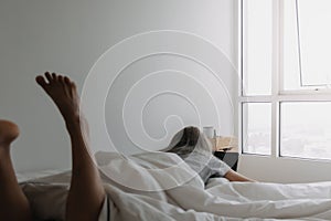 Woman sleep on tablet computer on bed in the morning. Early online work.