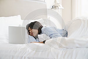 Woman sleep after use computer overwork on bed