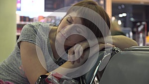 Woman sleeping at the airport waiting area. flight delay