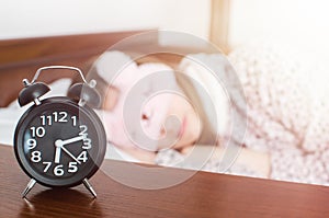 Woman sleeping with alarm clock