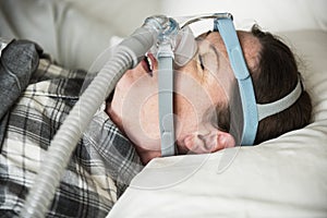 A woman sleeping with anti snoring chin strap