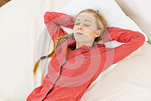 Woman sleeping in bed on back photo