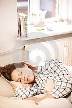 Woman, sleeping and bed in home for relaxing, dream or nap for tiredness with peace in morning. Girl, resting or fatigue