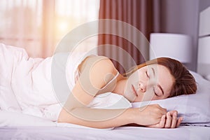 Woman sleeping on bed with soft light