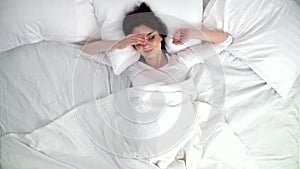 Woman Sleeping In Bed With White Linens At Home