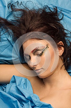 Woman sleeping in blue bedclothes photo