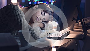 Woman sleeping on the desk at night