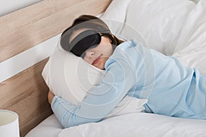 Woman Sleeping With Eyemask On Bed photo