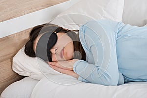 Woman Sleeping With Eyemask On Bed photo