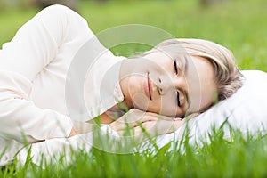 Woman sleeping on grass