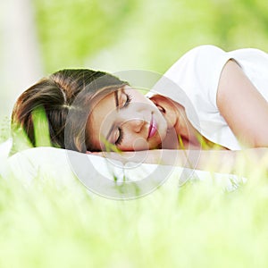 Woman sleeping on grass