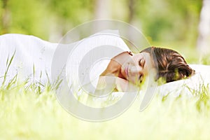 Woman sleeping on grass