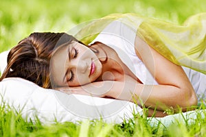 Woman sleeping on grass