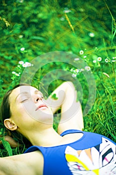 Woman sleeping on green grass