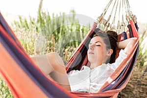 Woman sleeping on hammock