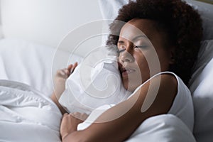 Woman sleeping in her bed