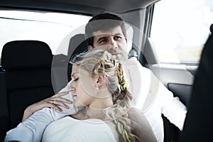 Woman sleeping on her husbands shoulder