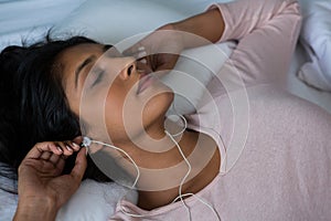 Woman sleeping while listening to music