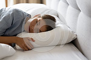 Woman sleeping on orthopaedic soft pillow close up shot