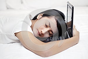 Woman sleeping over laptop