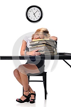 Woman sleeping over a pile of files