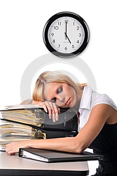 Woman sleeping over a pile of files photo