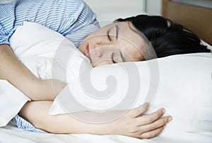 A woman sleeping peacefully on bed
