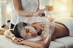 Woman, sleeping and relax in salt scrub massage at spa for skincare, exfoliation or body treatment. Calm female asleep