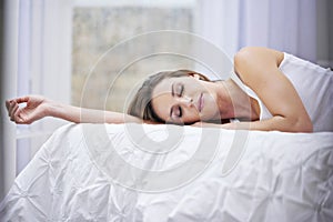 Woman, sleeping and relaxing in bed on weekend, lazy and comfortable on morning at home. Female person, peaceful and