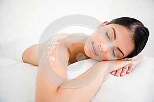 Woman sleeping with salt scrub on the back