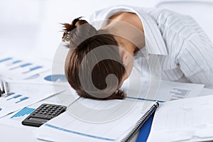 Woman sleeping at work in funny pose