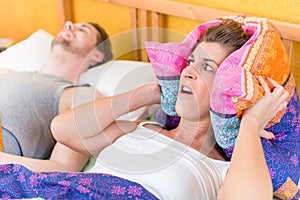 Woman is sleepless and angry because of her snoring husband