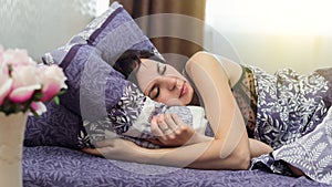 Woman sleeps sound restful sleep in her bed