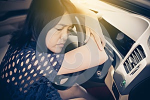 Woman sleepy tired and have a headache while driving car