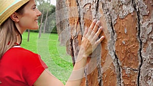 Woman sliding hand along old tree in slow motion. Female hand touching crust surface of tree trunk