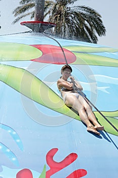 Woman sliding on wet bubble game pool