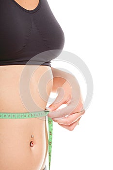 Woman slim stomach with measuring tape around it