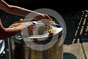 Woman, slim tanned girl, beekeeping work collecting honey. the worker`s hands are covered with a sticky sweet yellow liquid that r