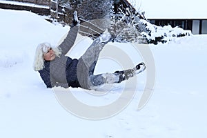 A woman slipped and fell on a snow covered road