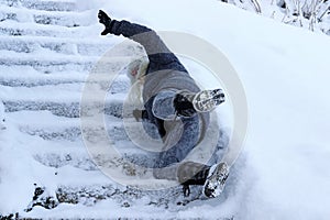 A woman slipped on the snow-covered stairs and fell