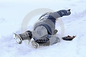 A woman slips on a snowy road